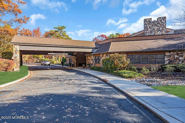 1396 Gleniffer Hill Rd, Toms River, NJ 08755 - view of front of house with driveway, stone siding, a chimney, and a carport