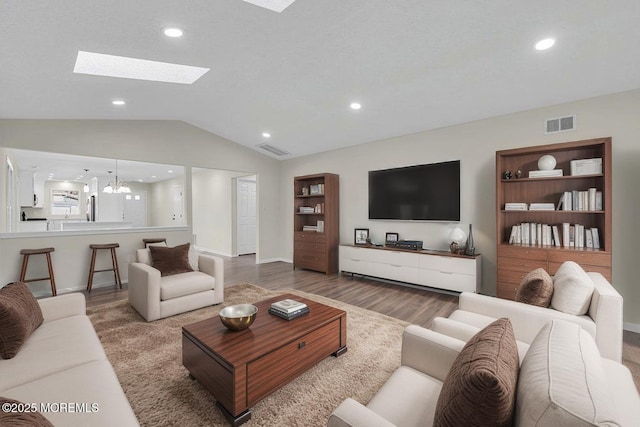1396 Gleniffer Hill Rd, Toms River, NJ 08755 - living room with recessed lighting, vaulted ceiling with skylight, wood finished floors, and visible vents