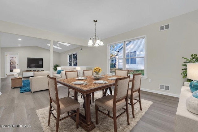 1396 Gleniffer Hill Rd, Toms River, NJ 08755 - dining room featuring light wood-style floors, lofted ceiling, visible vents, and a notable chandelier