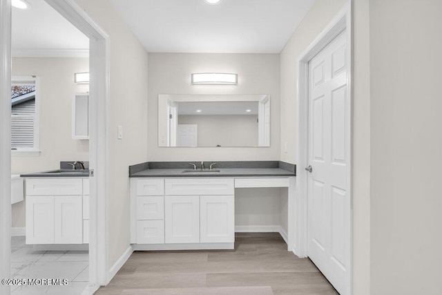 1396 Gleniffer Hill Rd, Toms River, NJ 08755 - bathroom with two vanities, wood finished floors, baseboards, and a sink