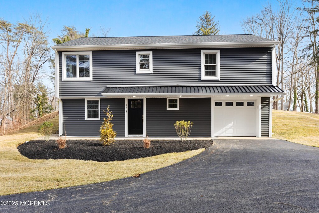 1104 Smithville Rd, Eastampton, NJ 08060 - view of front of home with an attached garage, aphalt driveway, and a front lawn