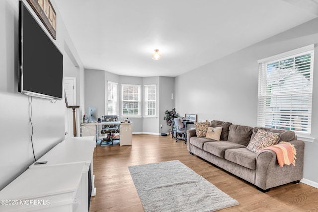 living room with light wood-style flooring and baseboards