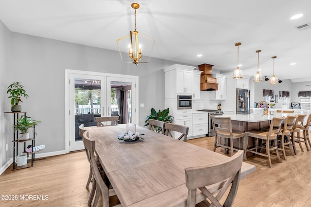 dining space featuring french doors, light wood finished floors, visible vents, and recessed lighting
