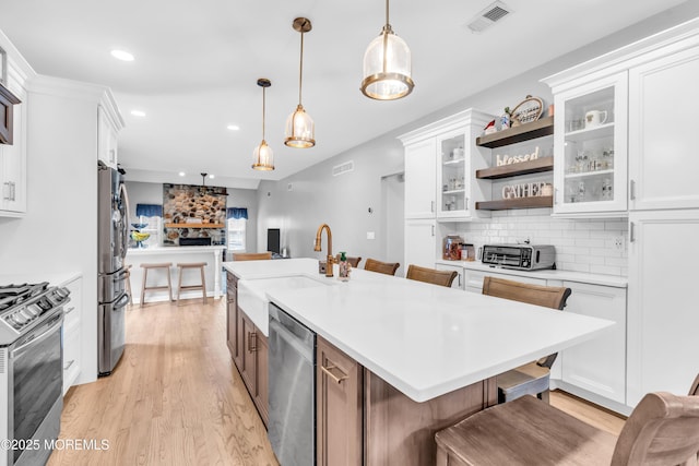 kitchen with visible vents, white cabinets, and appliances with stainless steel finishes