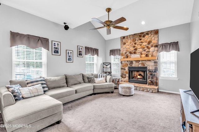 carpeted living room featuring a stone fireplace, a ceiling fan, baseboards, and lofted ceiling