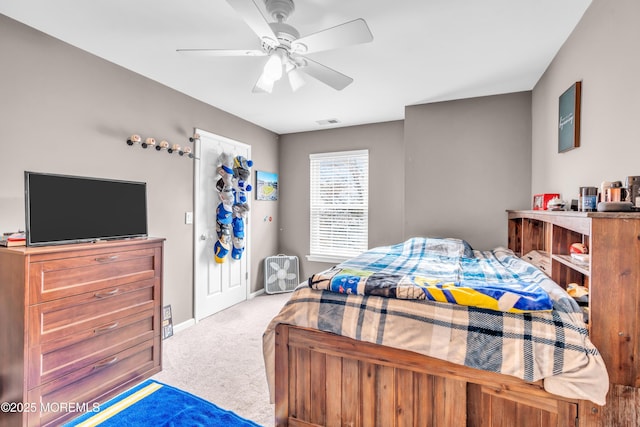 bedroom with carpet flooring, visible vents, baseboards, and a ceiling fan
