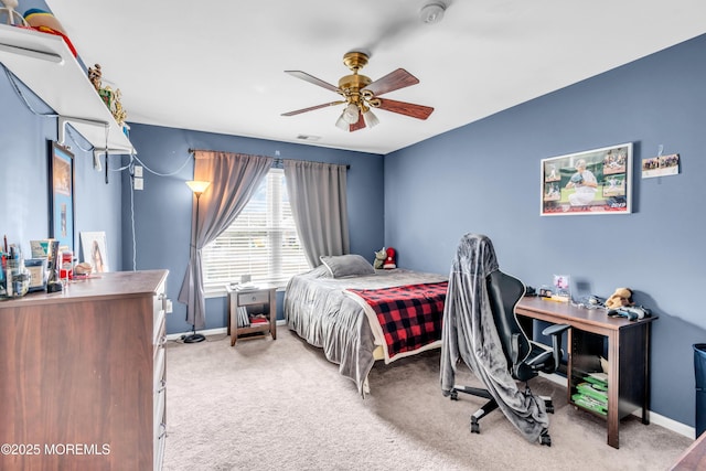 carpeted bedroom featuring visible vents, baseboards, and ceiling fan