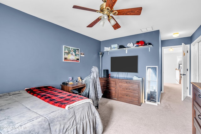 carpeted bedroom featuring visible vents and a ceiling fan