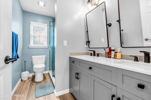 full bathroom with visible vents, a sink, and wood finished floors