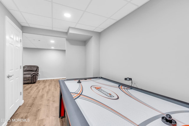 playroom with wood finished floors, baseboards, a drop ceiling, and recessed lighting