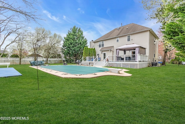 view of pool with a gazebo, a fenced backyard, a fenced in pool, and a wooden deck