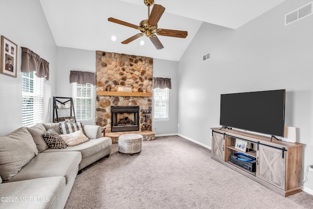 living room featuring carpet flooring, visible vents, ceiling fan, and a healthy amount of sunlight