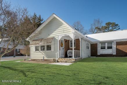 back of house with a lawn