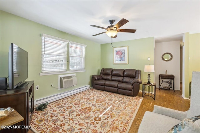 living room featuring wood finished floors, ceiling fan, an AC wall unit, and baseboard heating