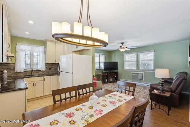 dining space featuring recessed lighting, a wall unit AC, and a ceiling fan