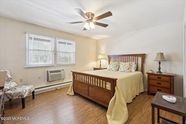 bedroom with a ceiling fan, wood finished floors, a wall unit AC, and a baseboard heating unit