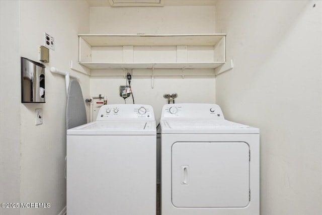 laundry room with washer and dryer and laundry area