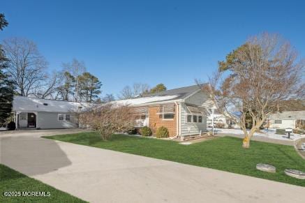 view of front of property with a front lawn and driveway