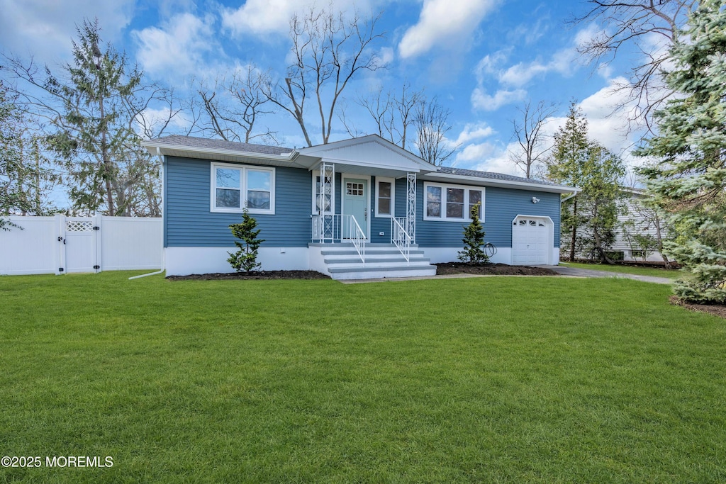 single story home with an attached garage, fence, a front lawn, a gate, and driveway