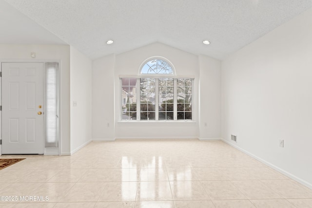 tiled foyer with baseboards, recessed lighting, a textured ceiling, visible vents, and lofted ceiling