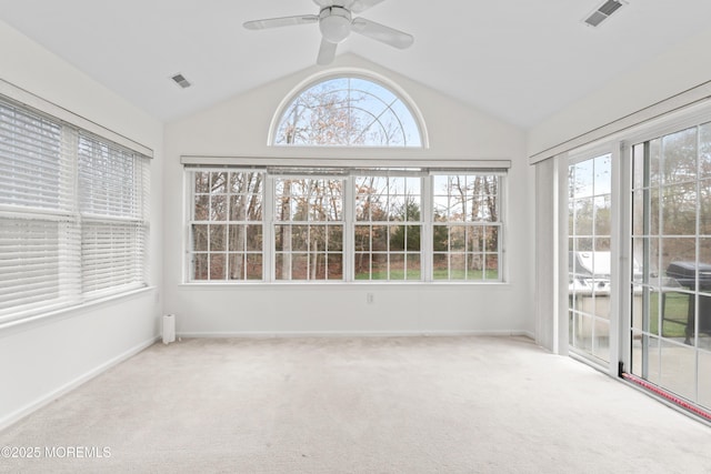 unfurnished sunroom featuring baseboards, lofted ceiling, carpet, and visible vents