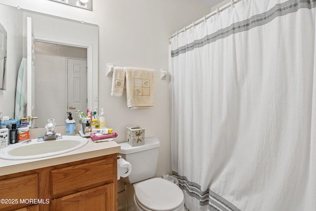 full bath featuring toilet, a shower with shower curtain, and vanity