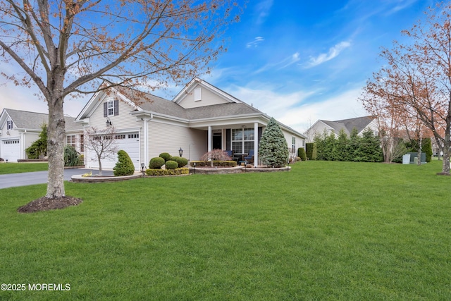 traditional-style house with a front yard, a shingled roof, and concrete driveway