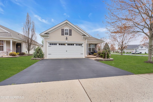 view of front of property featuring a front lawn and aphalt driveway
