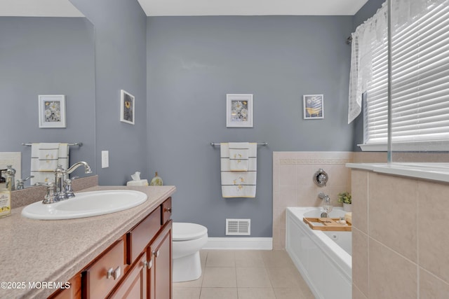 full bathroom with vanity, tile patterned flooring, toilet, visible vents, and a garden tub