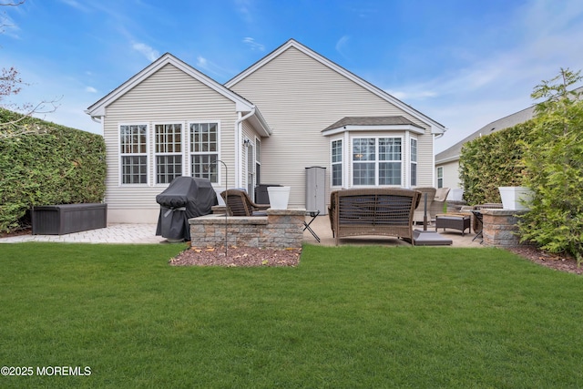 rear view of house with a patio and a yard