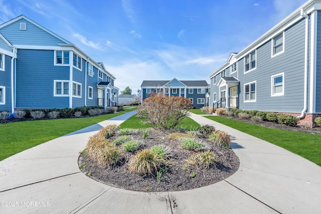 view of community featuring a residential view and a lawn