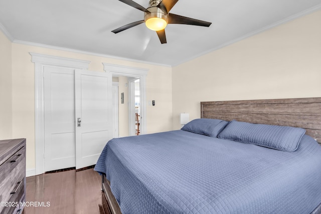 bedroom with dark wood-type flooring, ornamental molding, and a ceiling fan