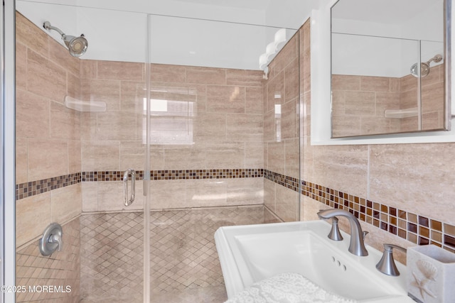 bathroom featuring a shower stall and a sink