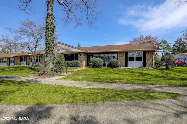 single story home with brick siding and a front lawn