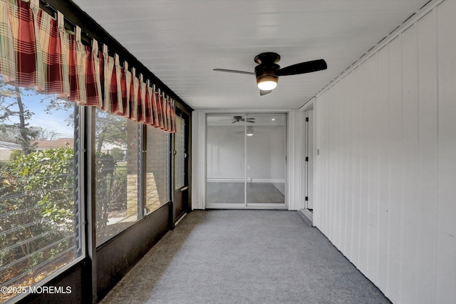 unfurnished sunroom with ceiling fan