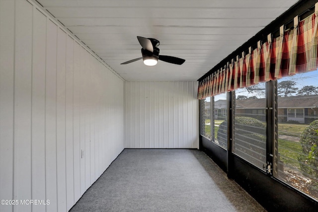 unfurnished sunroom with a ceiling fan