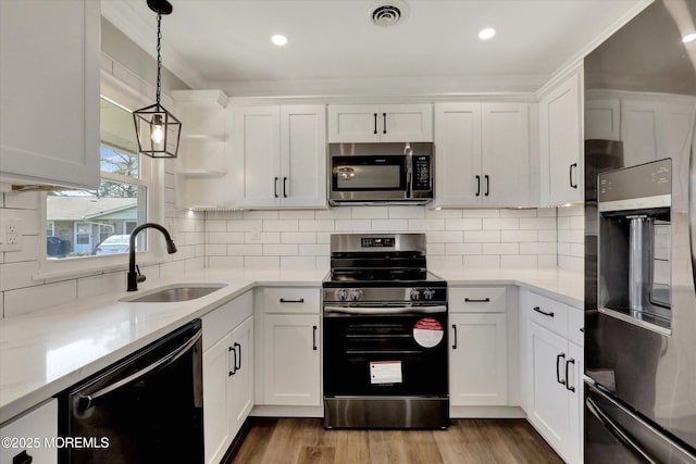 kitchen featuring white cabinets, visible vents, a sink, and appliances with stainless steel finishes