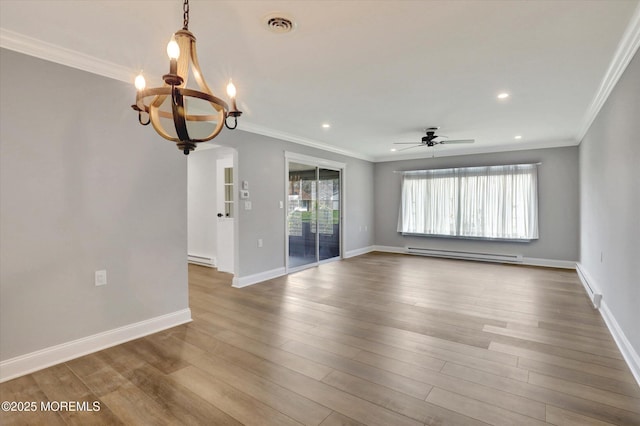spare room featuring baseboard heating, ceiling fan with notable chandelier, visible vents, and ornamental molding