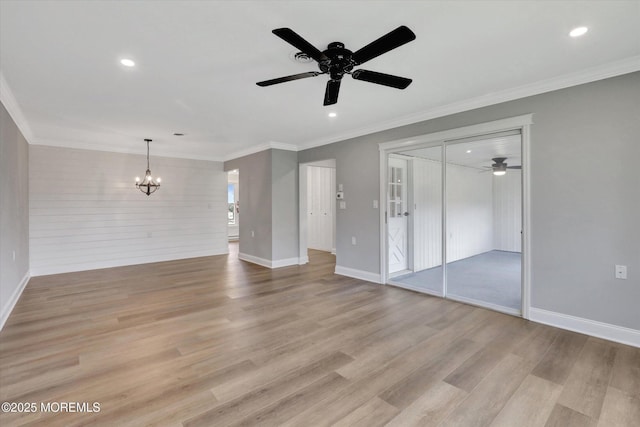 unfurnished living room featuring baseboards, light wood-type flooring, and ceiling fan with notable chandelier