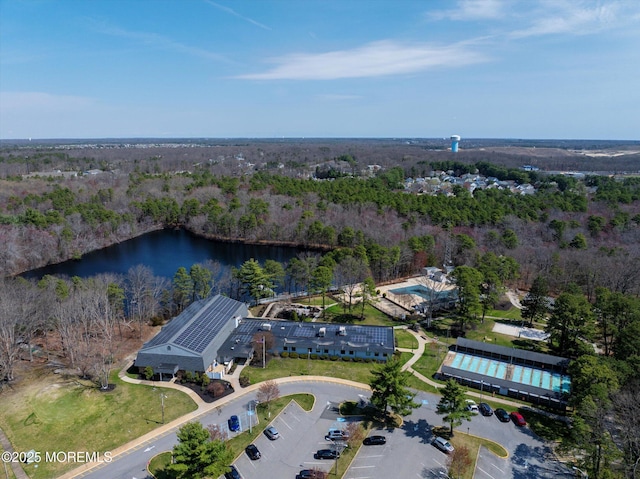 drone / aerial view featuring a view of trees and a water view