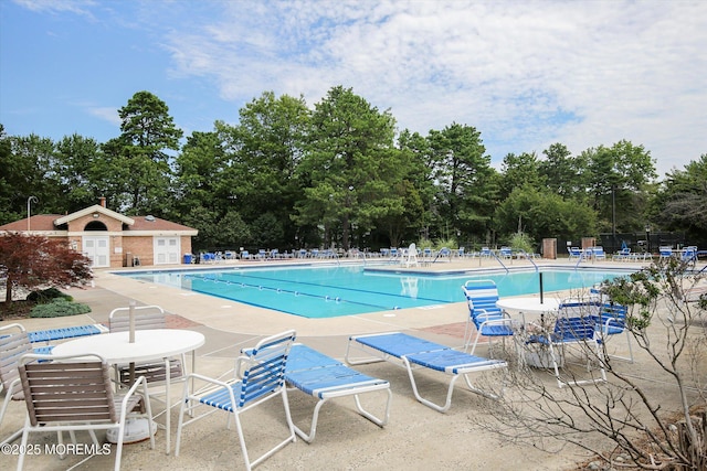 pool featuring fence and a patio