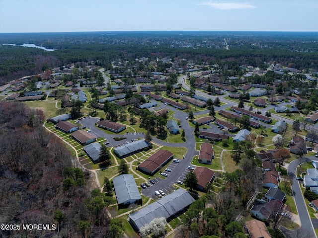 birds eye view of property featuring a forest view and a residential view