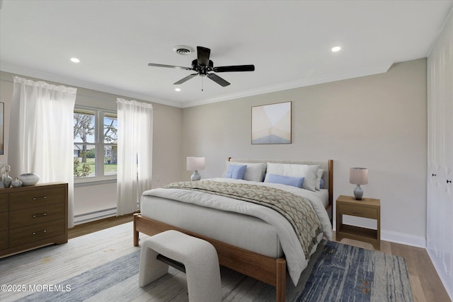 bedroom featuring visible vents, recessed lighting, wood finished floors, and baseboard heating