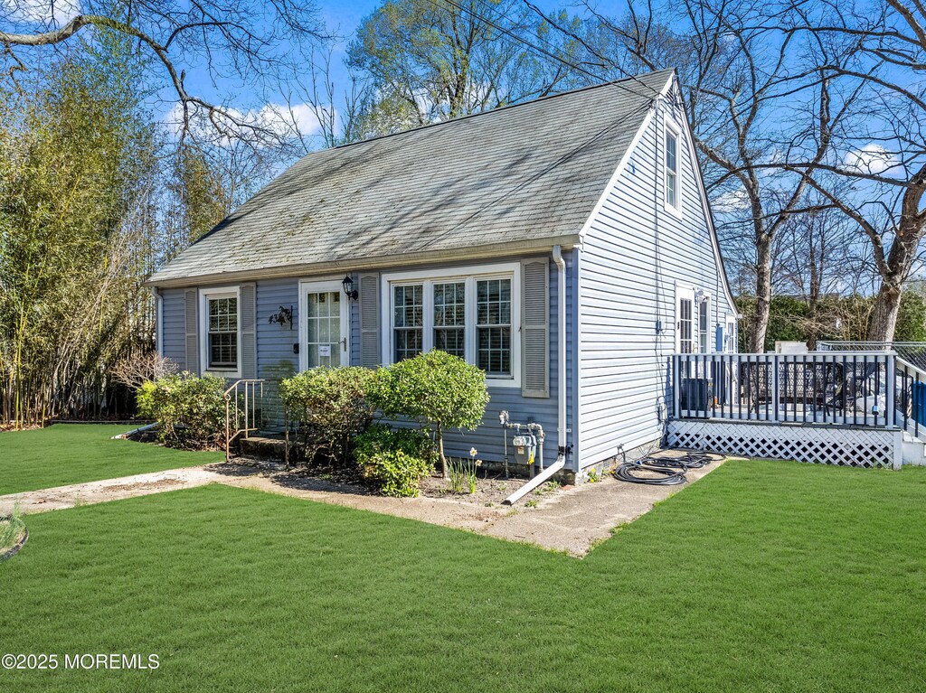 438 Shady Ln, Howell, NJ 07731 - view of front of home with a front lawn, a deck, and roof with shingles