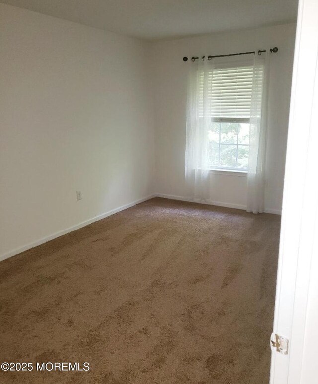 96 Drew Ct, Manalapan, NJ 07726 - carpeted empty room with baseboards