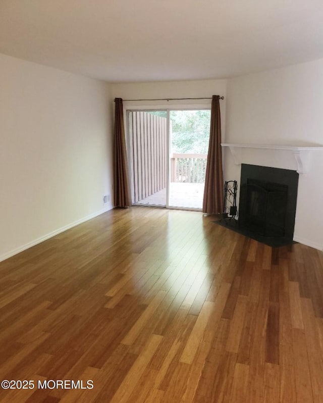 96 Drew Ct, Manalapan, NJ 07726 - unfurnished living room featuring a fireplace, baseboards, and wood finished floors