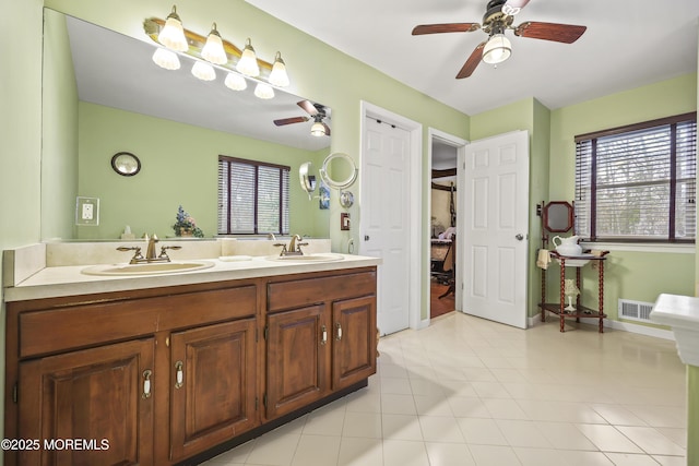 bathroom featuring double vanity, visible vents, a ceiling fan, and a sink