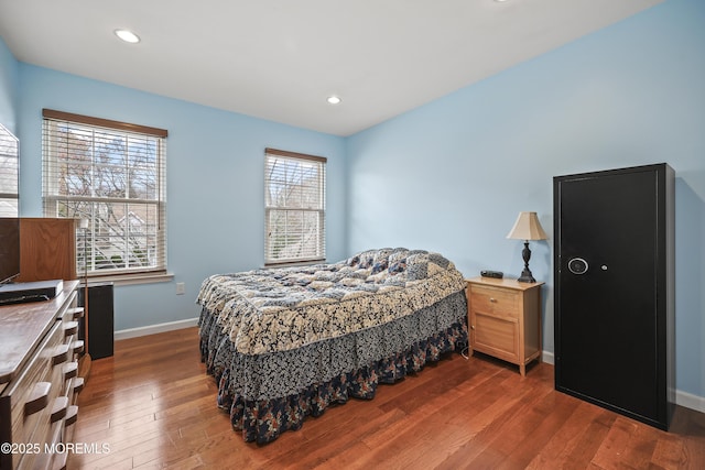 bedroom with baseboards, recessed lighting, and dark wood finished floors