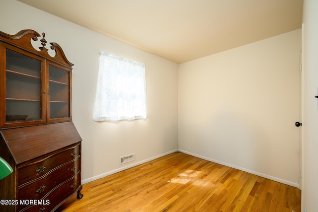 unfurnished bedroom featuring visible vents, baseboards, and light wood-style floors