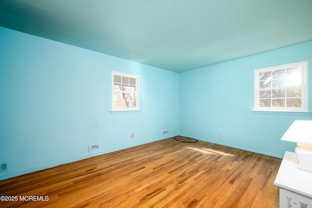 empty room with visible vents and light wood-type flooring